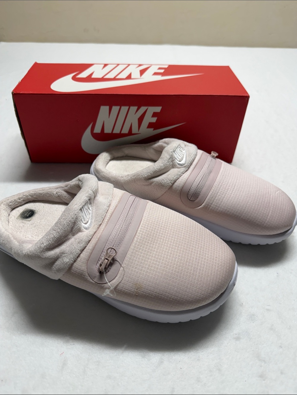 Nike womenโs Slip-On Sneakers in Light Pink and White 8
